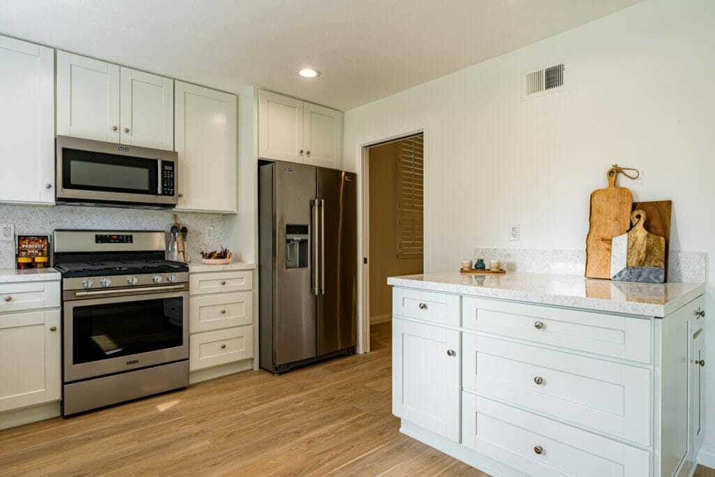 A recently remodeled kitchen with a coffee bar and stainless steel appliances.