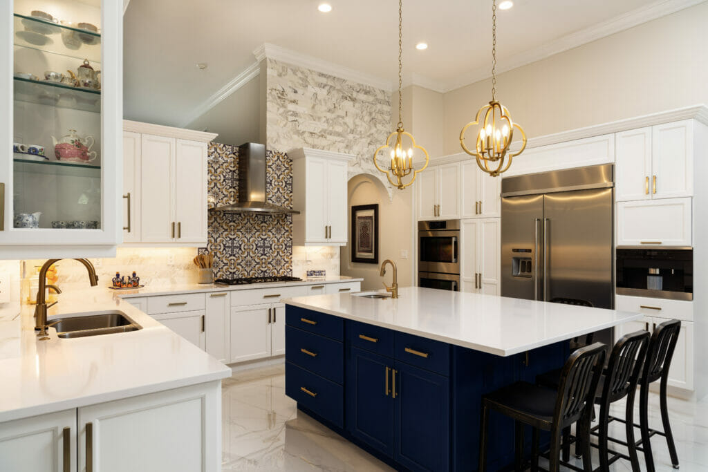 A recently remodeled kitchen with white cabinetry and a blue island.