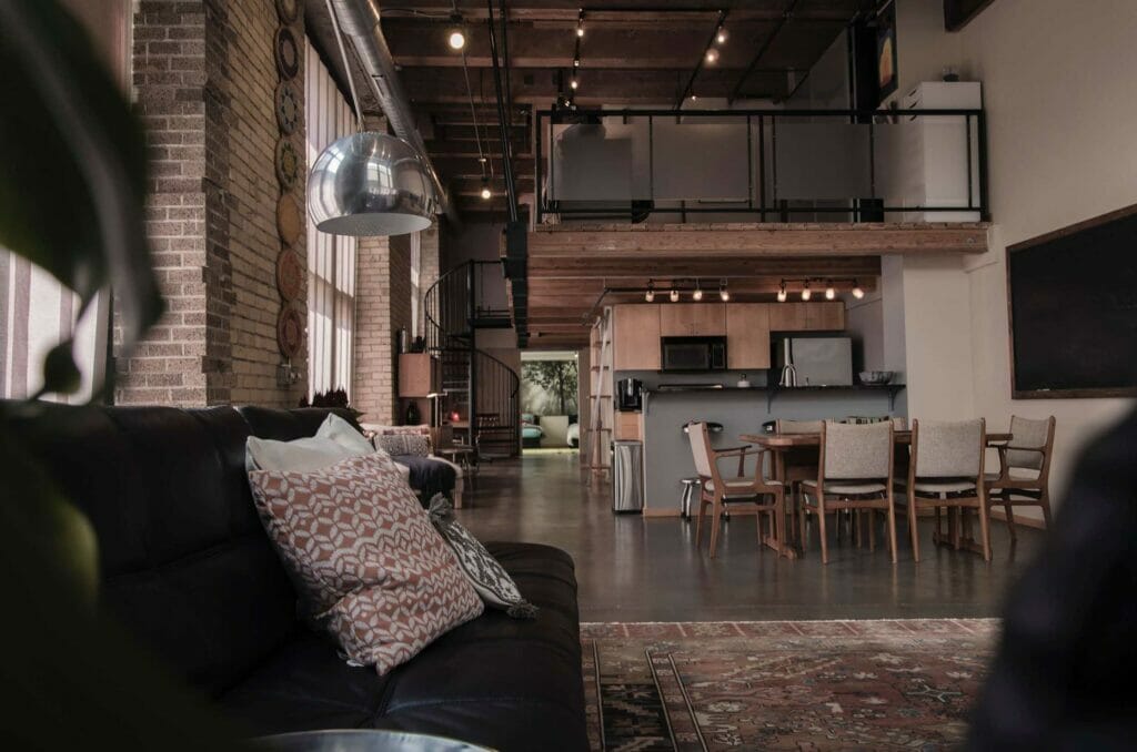 Industrial style interior shot of living room and kitchen.