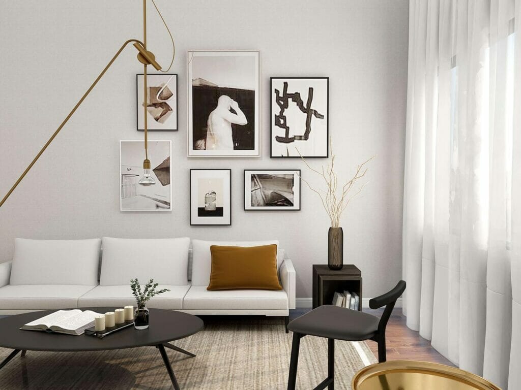 A modern home’s living room with a gallery wall and a white couch.
